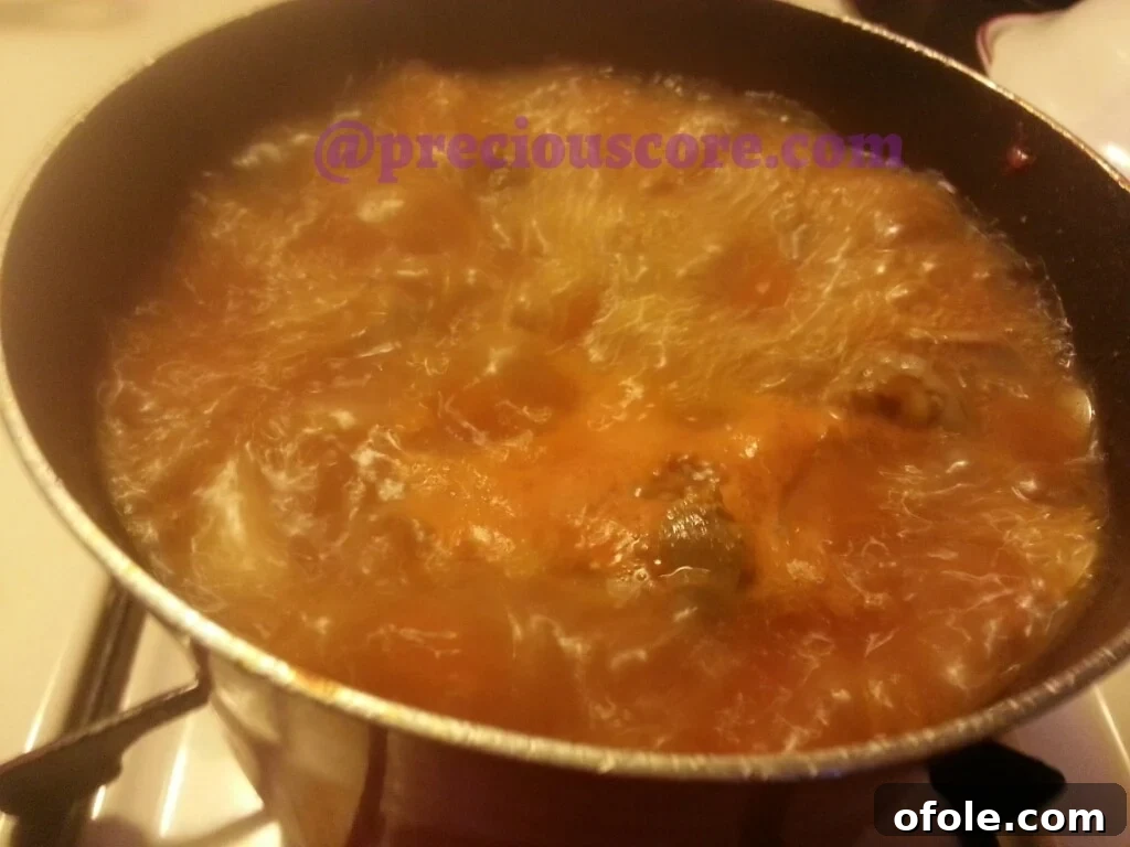 Flavorful Peppered Gizzard Delight 6 Adding blended aromatics and tomato paste to gizzards