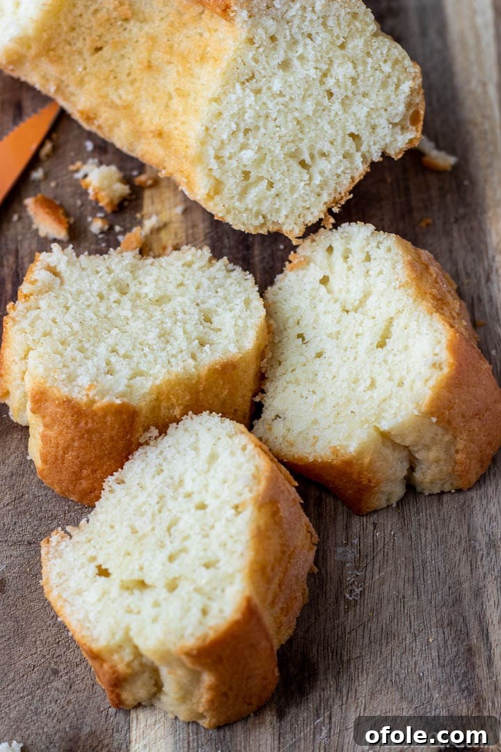 Individual slices of yogurt cake arranged on a wooden chopping board, ready to be served.