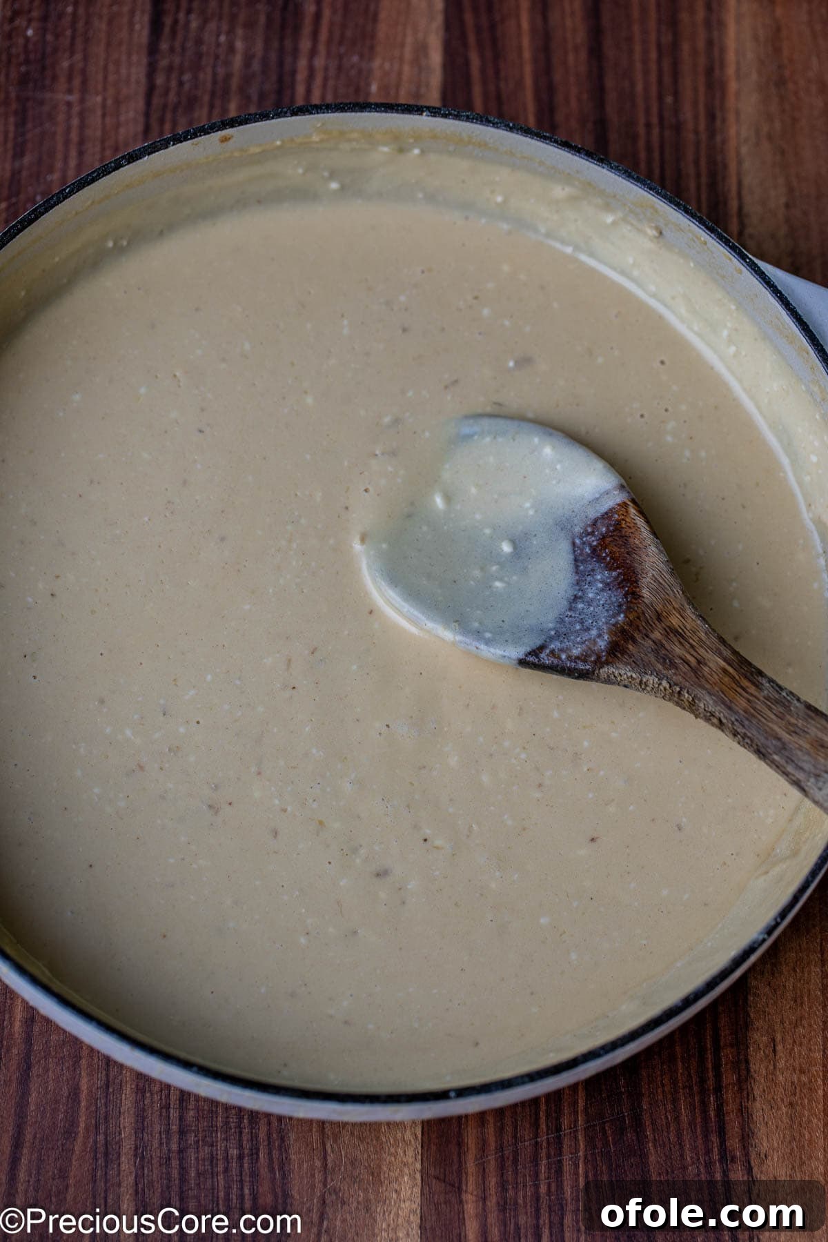 Parmesan Chicken Pasta with Garlic Cream Sauce 11 A rich, creamy white sauce simmering beautifully in a pot.