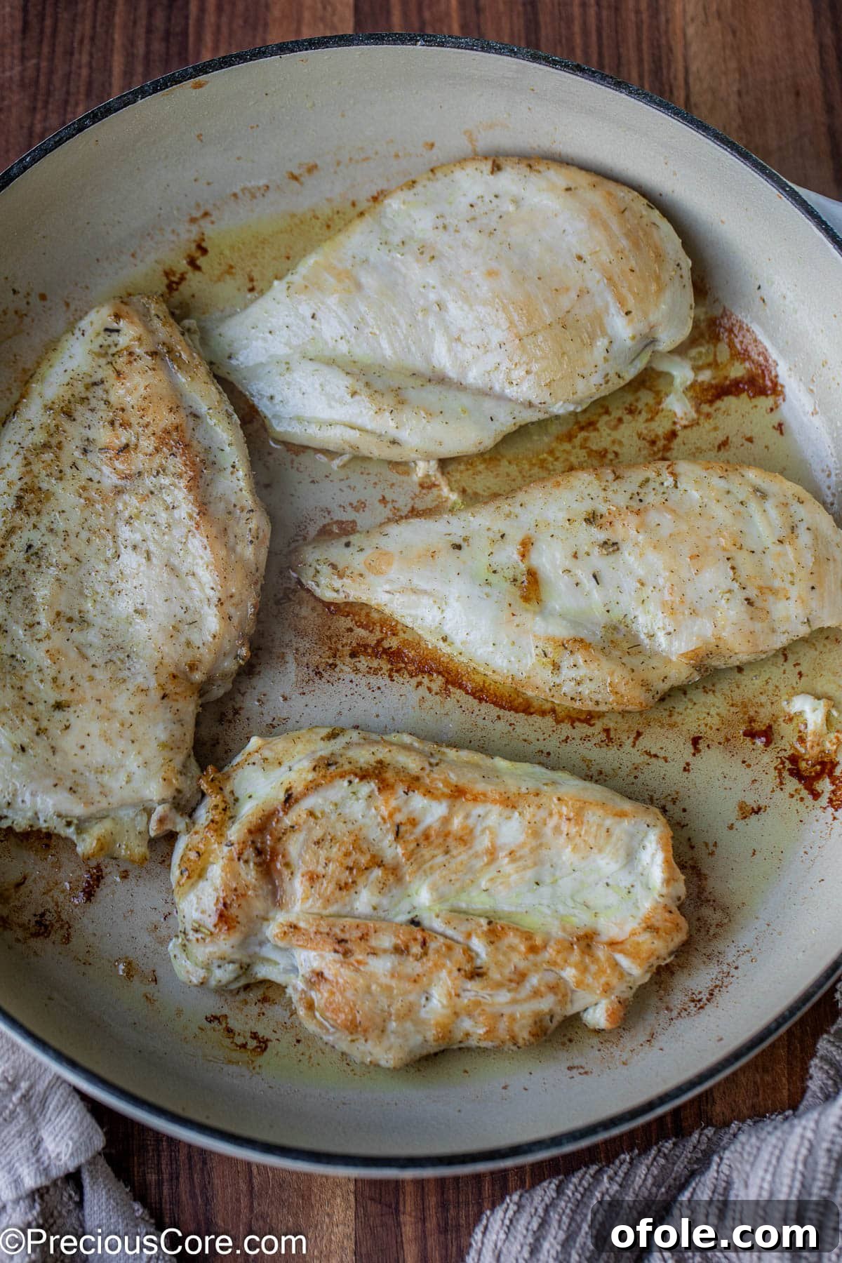 Parmesan Chicken Pasta with Garlic Cream Sauce 8 Perfectly cooked chicken breasts resting in a cast iron pot after searing.