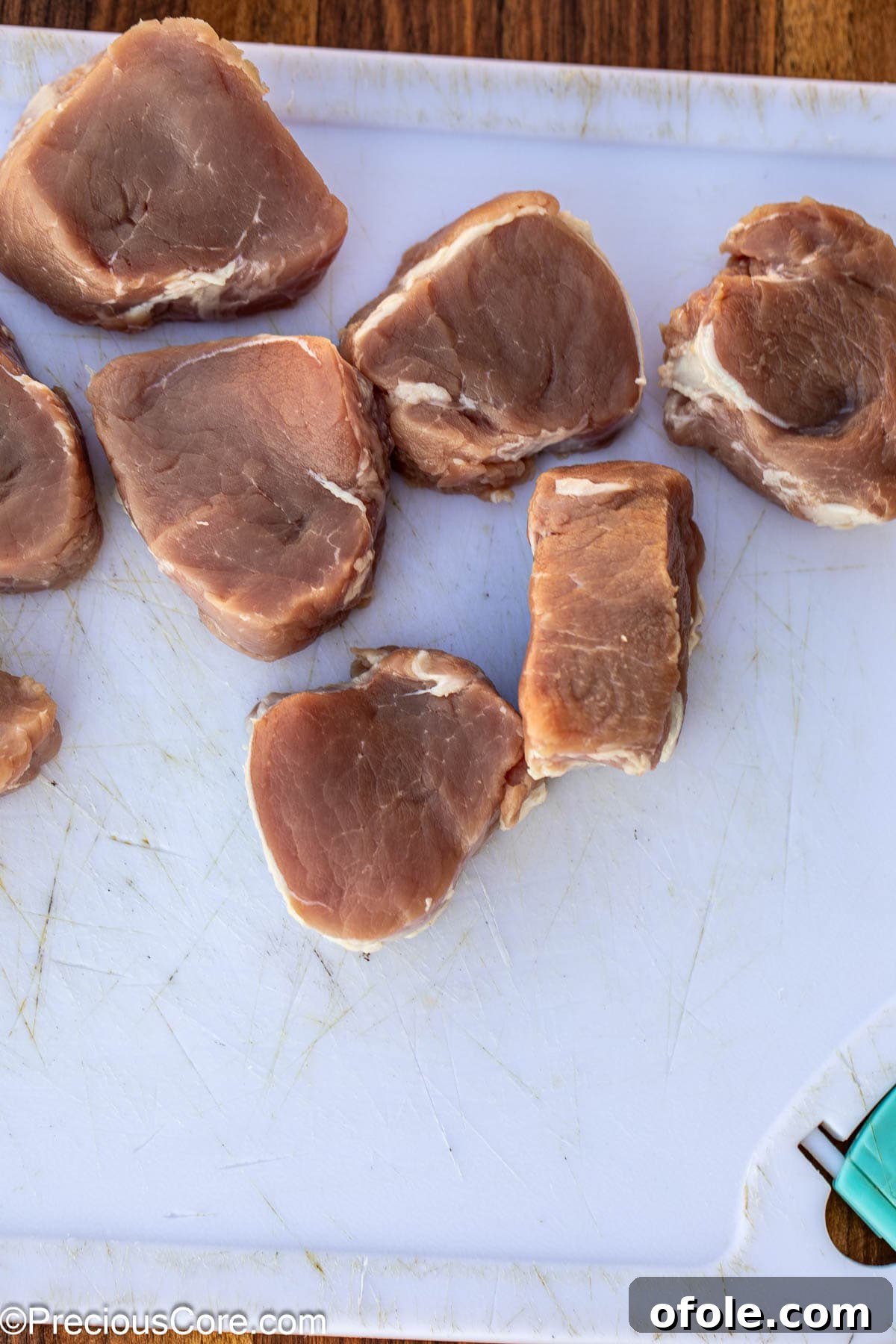 Pan-Seared Pork Tenderloin with Velvety Mushroom Sauce 6 Sliced pork tenderloin on chopping board.