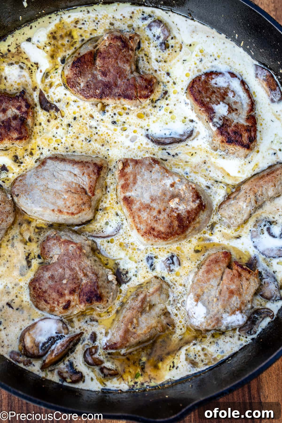 Pan-Seared Pork Tenderloin with Velvety Mushroom Sauce 10 Sauce in a skillet with round slices of meat.
