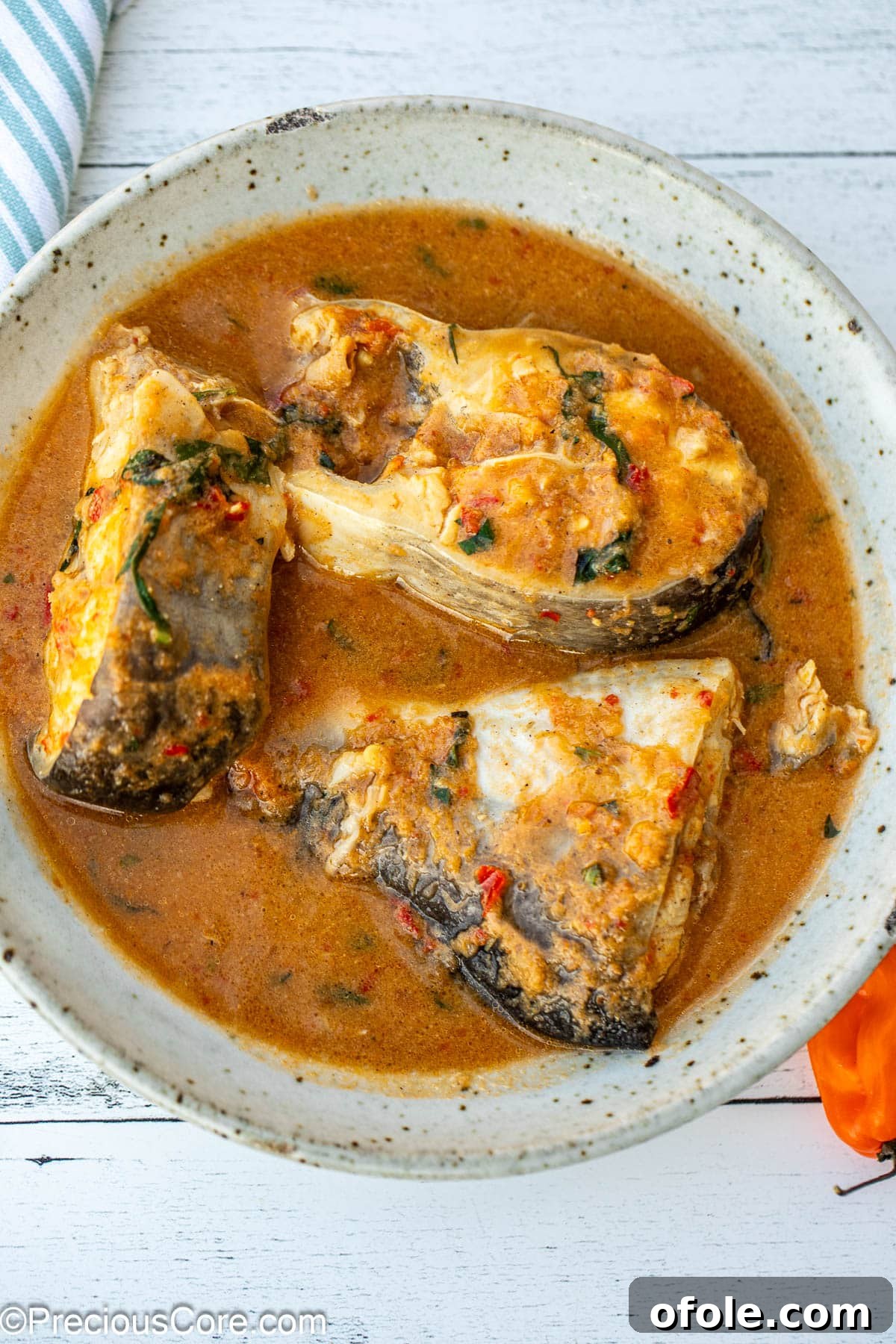 Zesty Catfish Pepperpot 2 A bowl with three steaks of catfish in pepper soup.