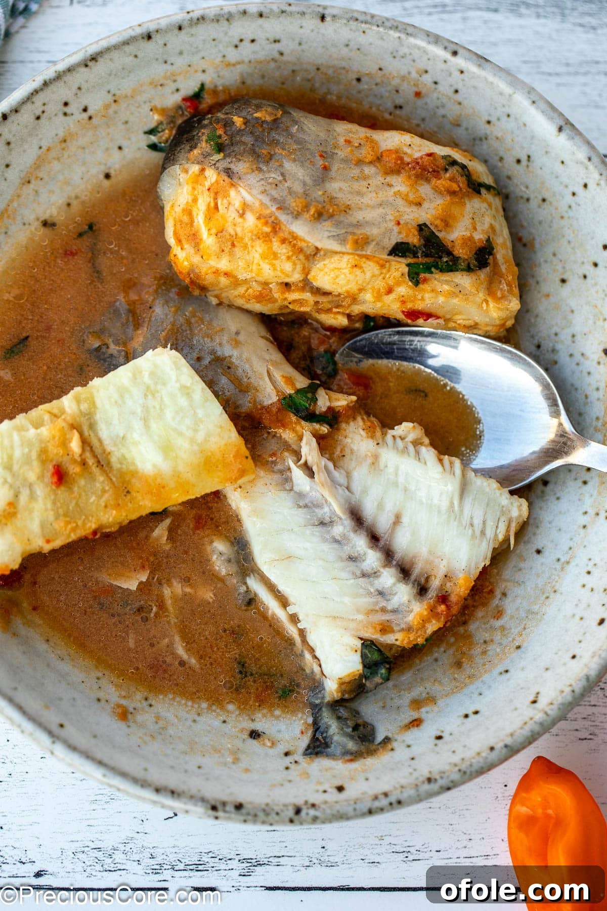 Zesty Catfish Pepperpot 7 Fish tail in a broth served with African white yam.