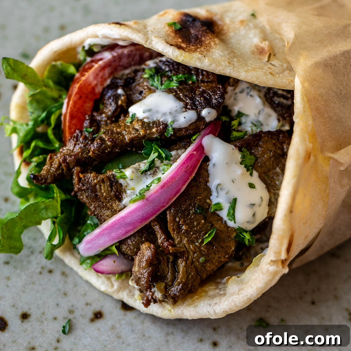 Authentic Shawarma Sauce 8 Close up image of a delicious beef shawarma wrap, perfectly assembled.