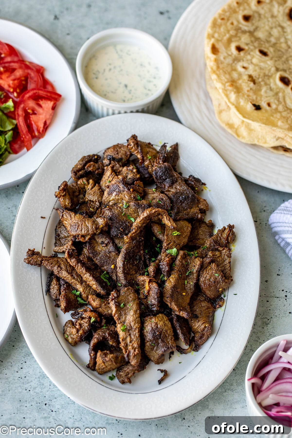 Beef shawarma on a platter, ready to be served in wraps or bowls.