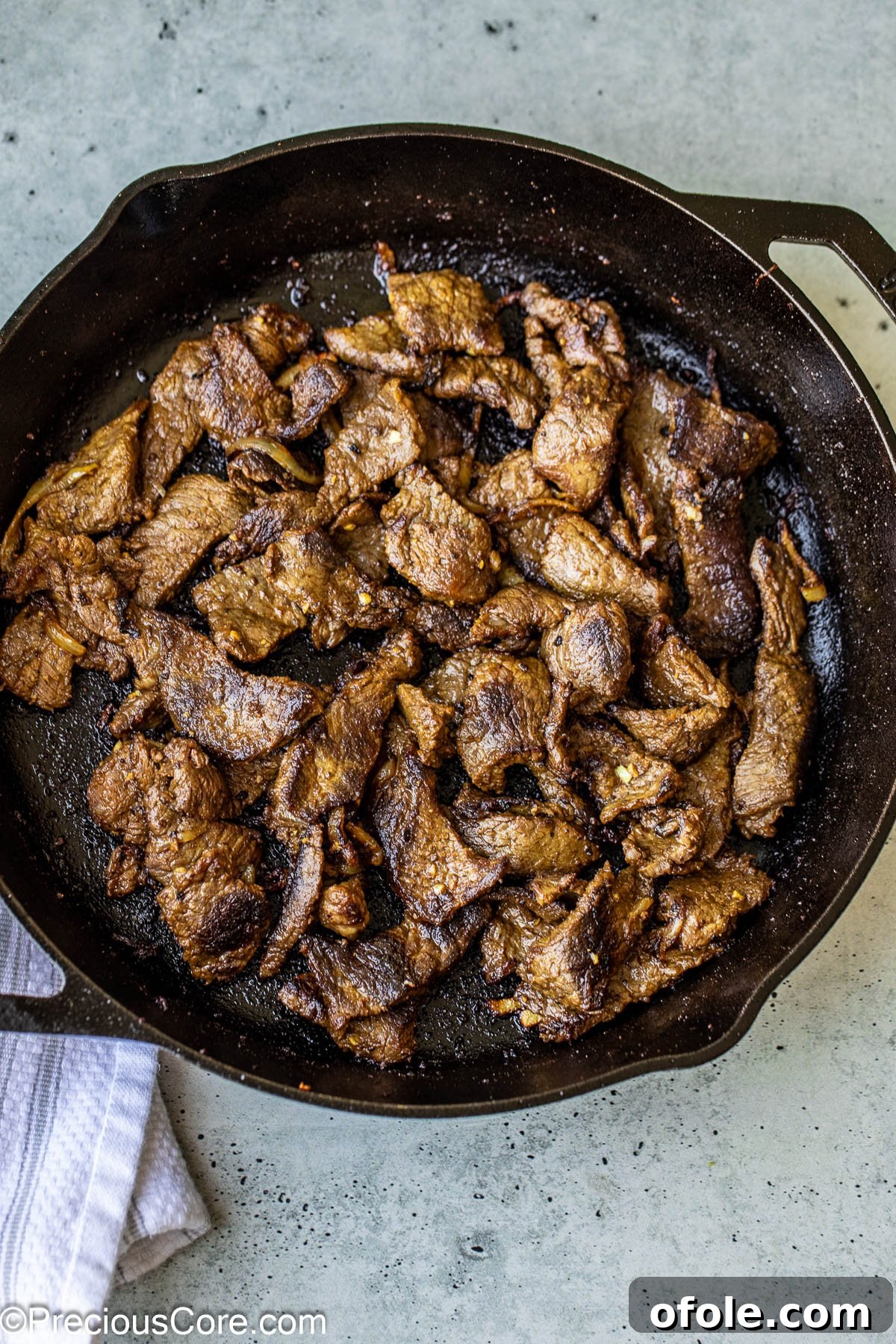 Perfectly cooked beef shawarma, browned and tender, resting in a cast iron pan.