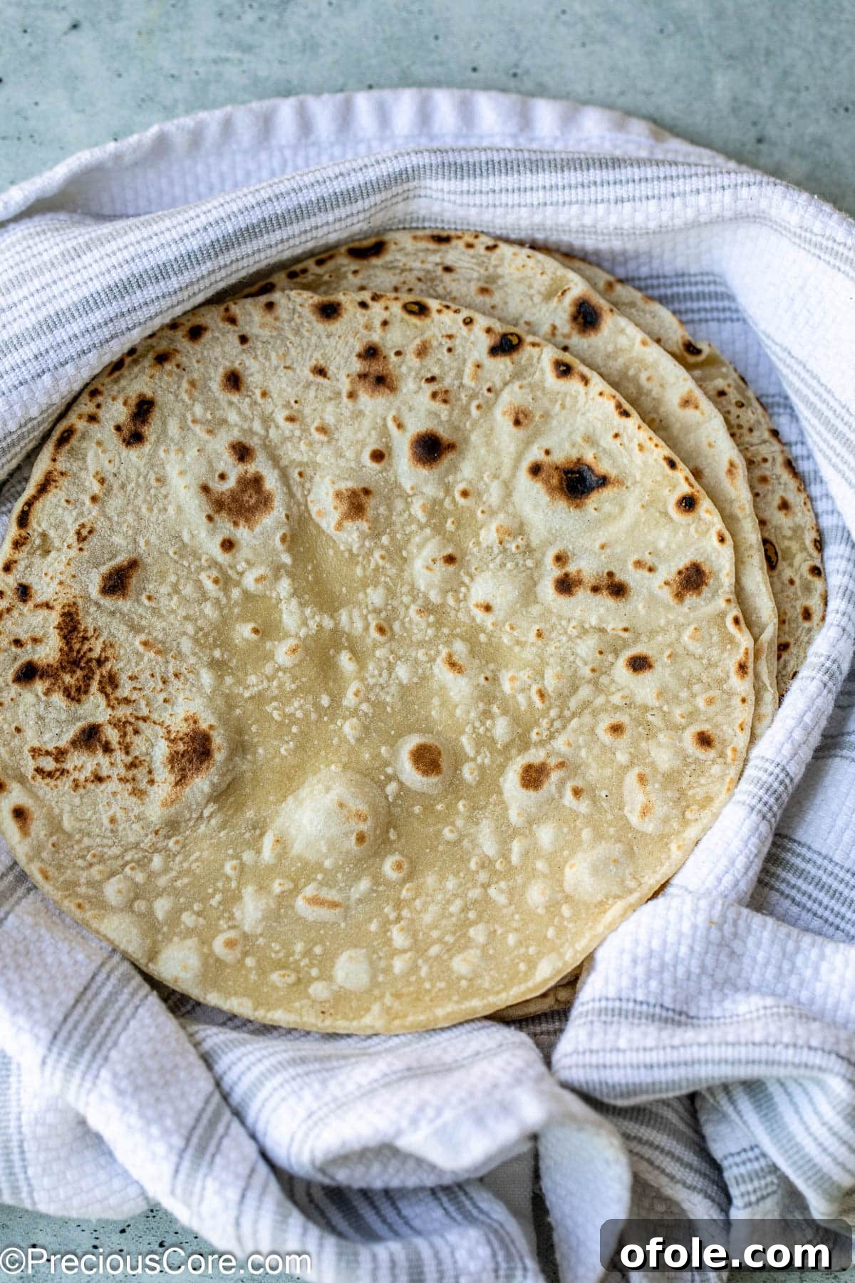 Shawarma Flatbread Delights 2 Freshly made, soft shawarma bread resting on a linen cloth, ready to be served.