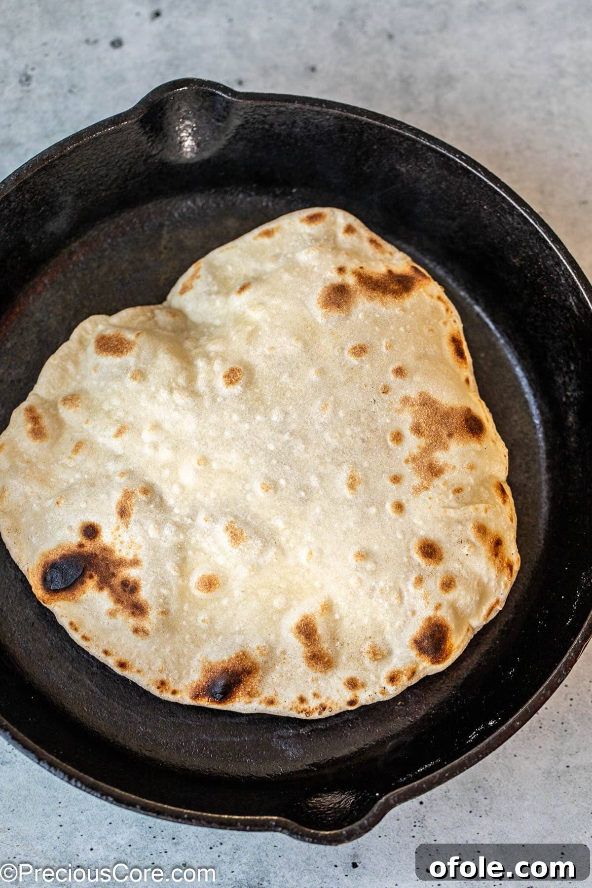 Shawarma Flatbread Delights 11 Shawarma bread vigorously puffing up in a hot skillet, a clear sign of proper cooking and perfect texture.