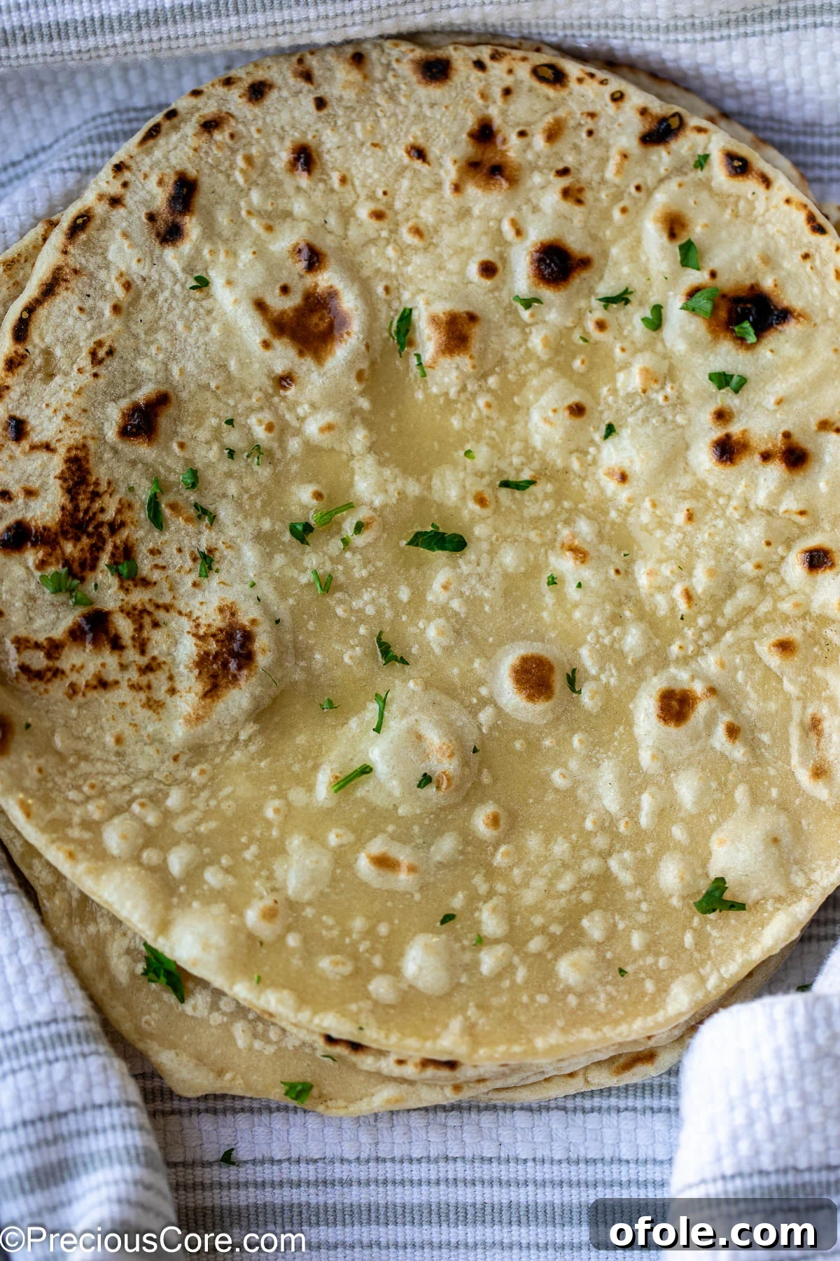 Shawarma Flatbread Delights 12 Freshly cooked shawarma bread, garnished with a generous sprinkle of minced fresh parsley for added flavor and visual appeal.