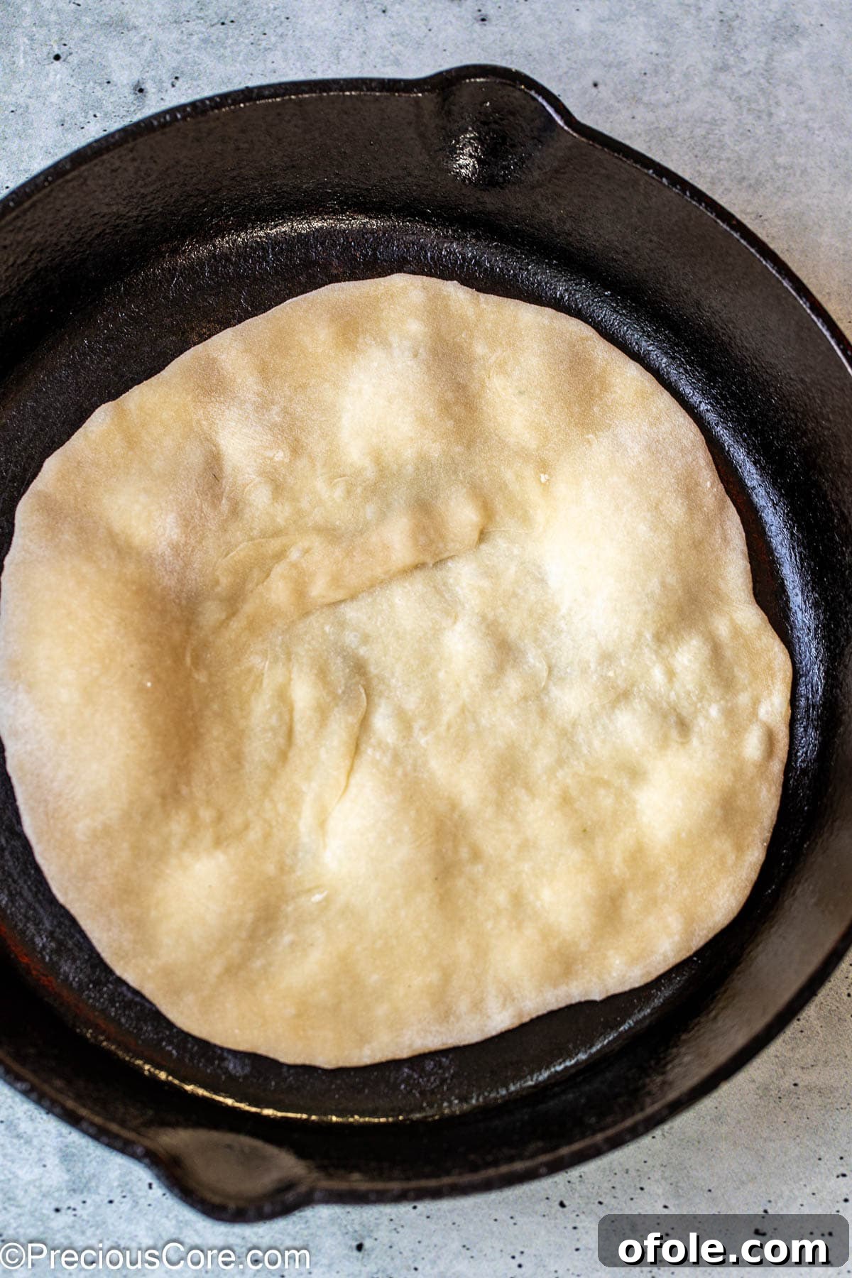 Shawarma Flatbread Delights 10 A piece of shawarma bread cooking in a hot skillet, puffing up beautifully as it cooks.