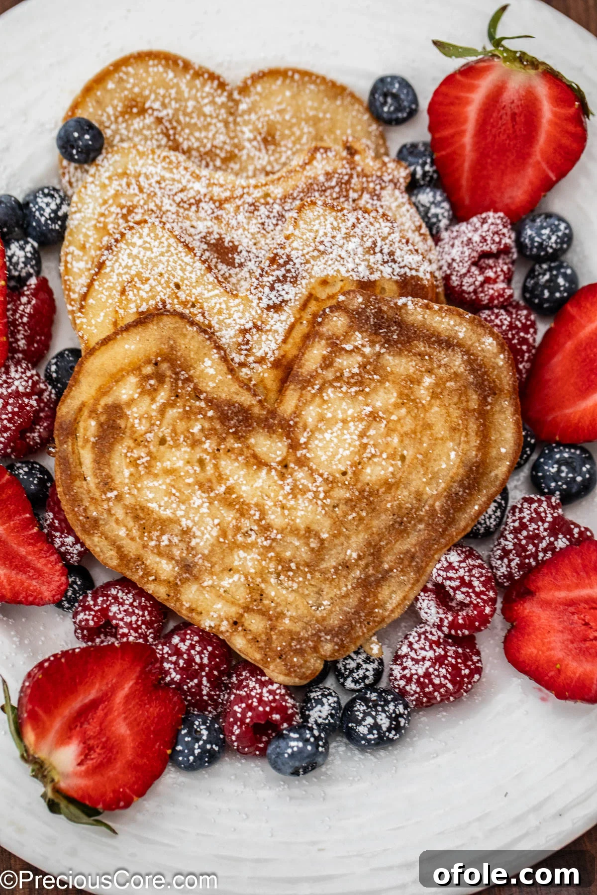 Sweetheart Flapjacks 8 Perfectly golden-brown pancakes expertly shaped into hearts, ready to be served.