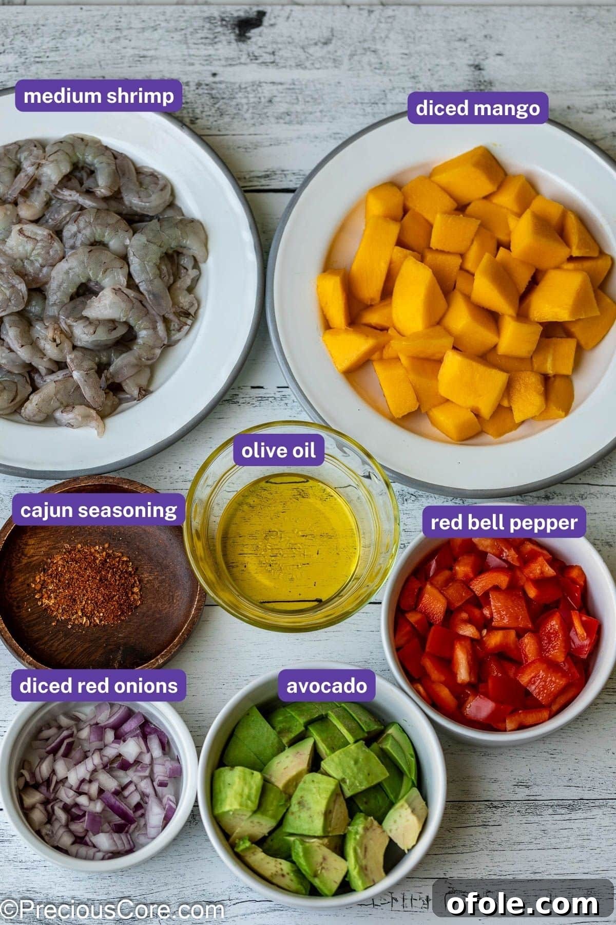 Tropical Mango Prawn Salad 3 All the fresh ingredients laid out for making a delicious Mango Shrimp Salad, including mango, shrimp, avocado, and bell peppers.
