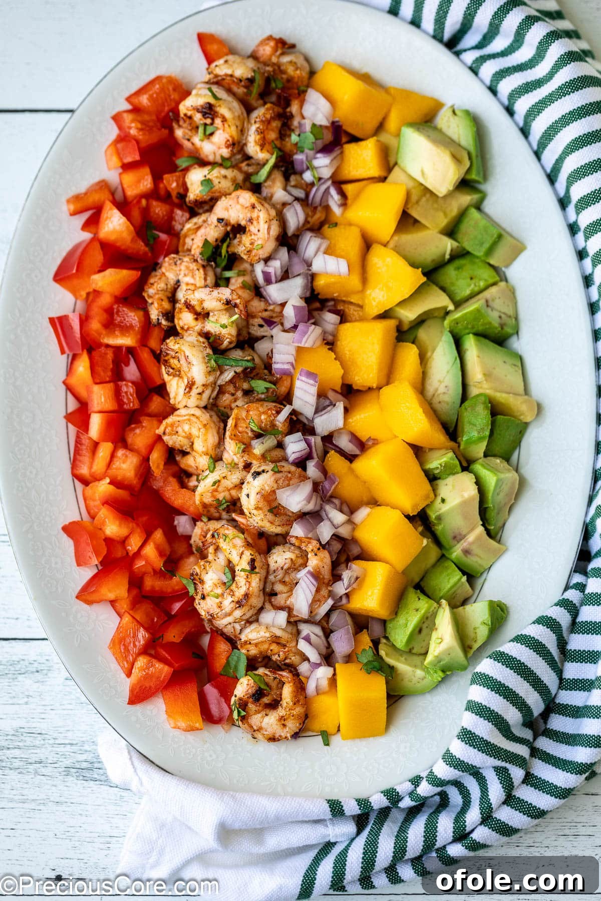 Tropical Mango Prawn Salad 6 All the vibrant ingredients for Mango Avocado Salad laid out on a platter before mixing with dressing.