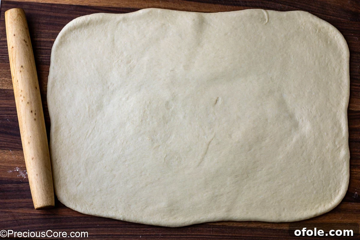 Luscious Strawberry Cinnamon Rolls 12 Cinnamon roll dough rolled into a perfect rectangle on a floured surface.