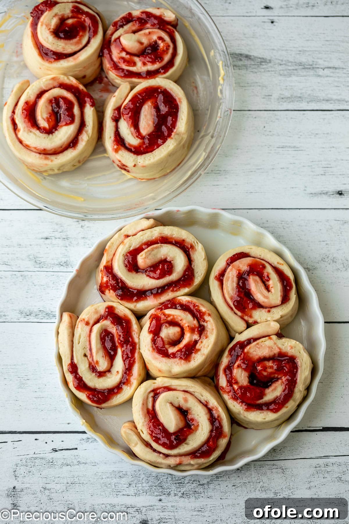 Luscious Strawberry Cinnamon Rolls 16 Unbaked strawberry cinnamon rolls arranged in a round baking dish, ready for the oven.