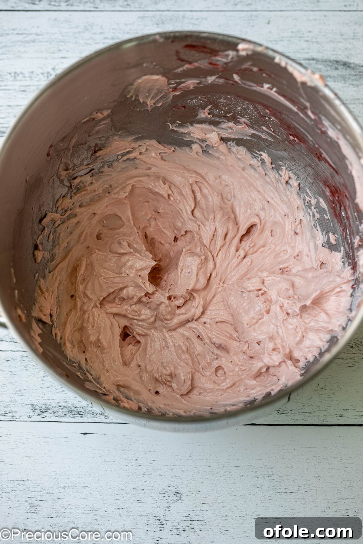 Luscious Strawberry Cinnamon Rolls 18 Smooth and creamy strawberry cream cheese frosting in a mixing bowl.