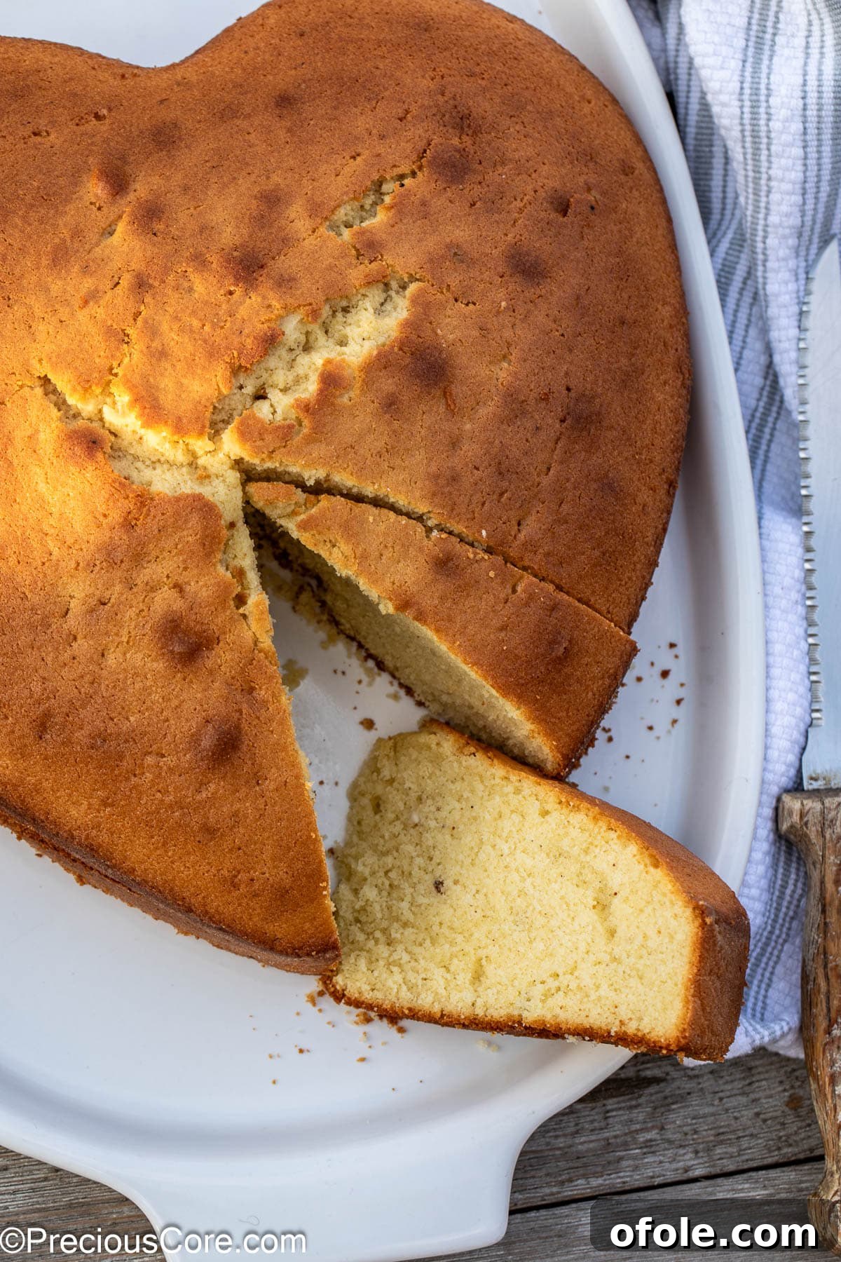 Effortless Everyday Cake 3 A delicious plain cake with several slices already removed, showing its moist and airy crumb.