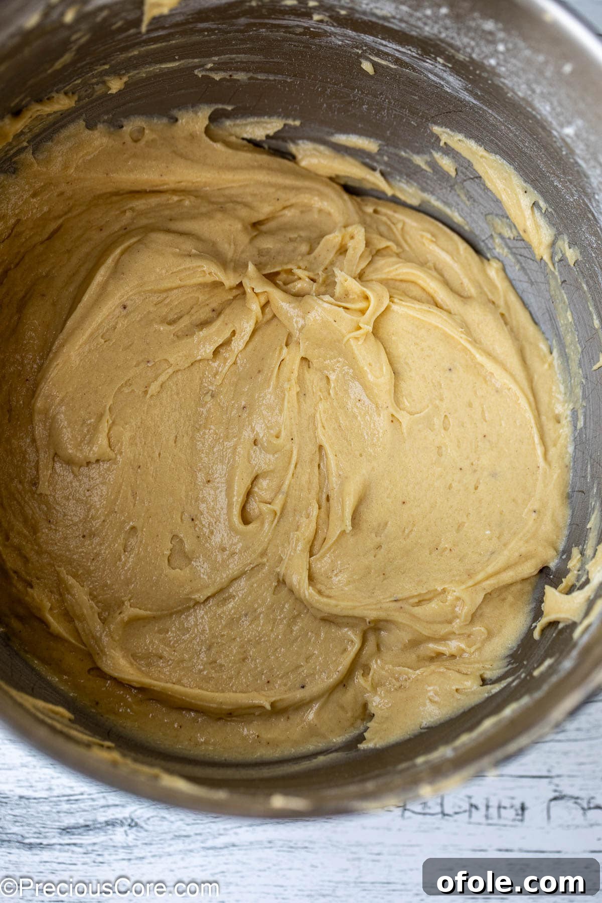 Effortless Everyday Cake 8 The fully mixed, smooth cake batter resting in a shining metal mixing bowl, ready for baking.