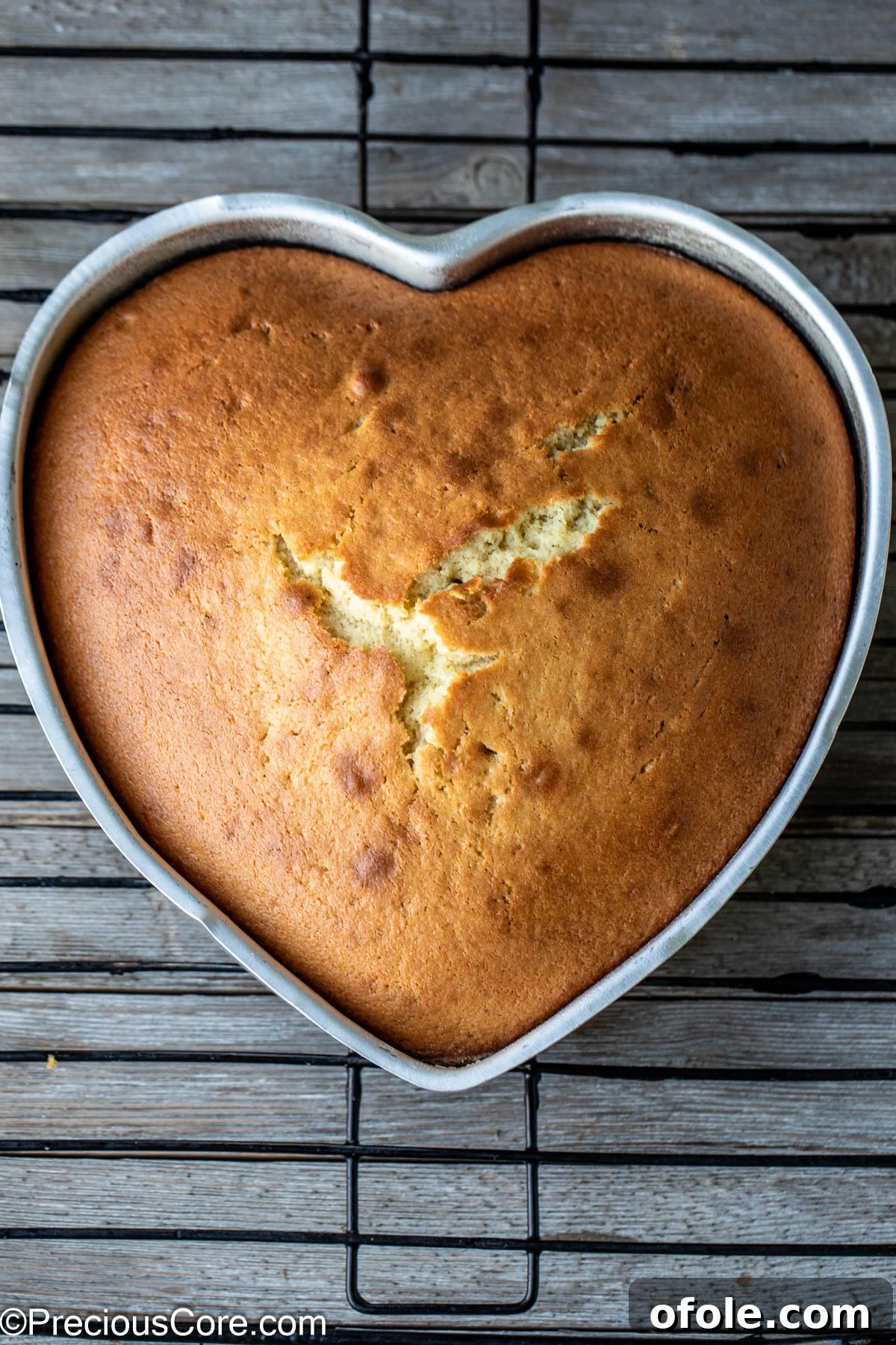 Effortless Everyday Cake 10 A golden-brown heart-shaped plain cake cooling gracefully on a wire rack, ready to be enjoyed.