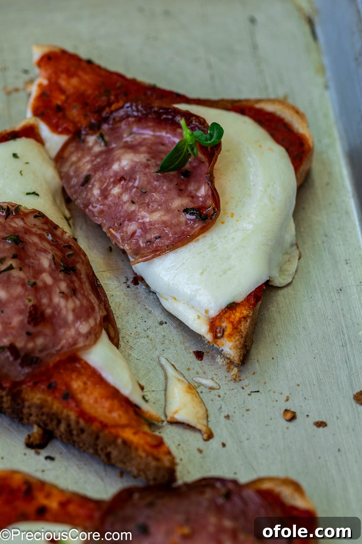 Close-up of a triangle of pizza toast.