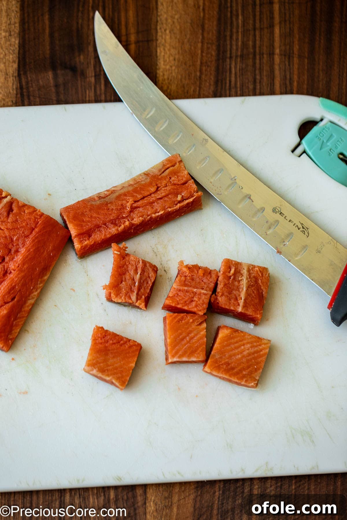 Spicy Cajun Salmon Pasta 6 Cutting salmon into bite-sized pieces for the pasta.