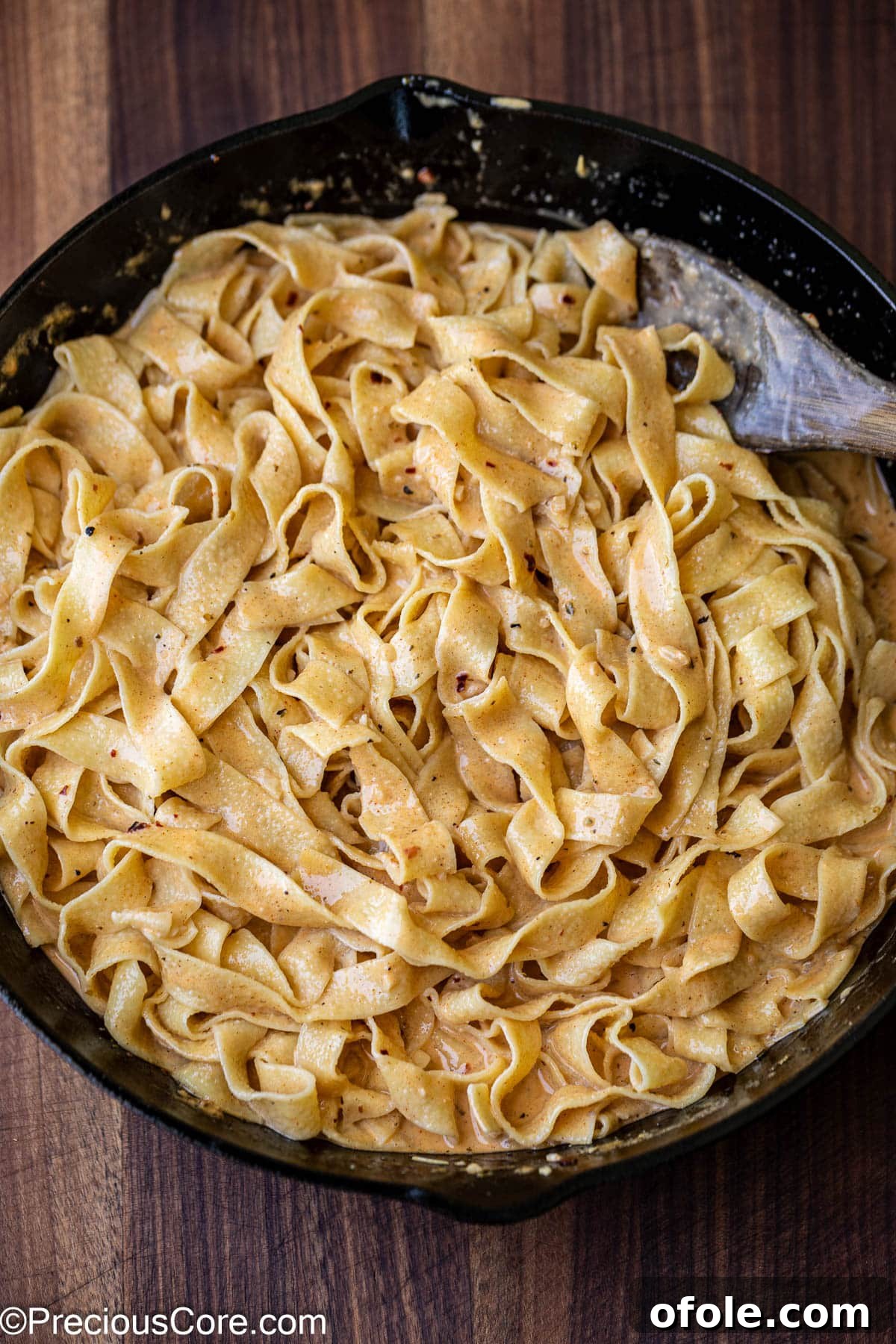 Spicy Cajun Salmon Pasta 10 Mixing cooked pasta with the homemade creamy sauce.