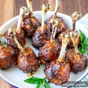Plate of baked and glazed chicken lollipops.