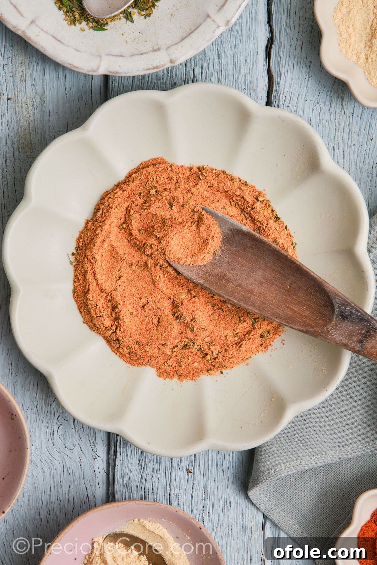 Cajun Flavor Hacks 2 Wooden spoon in a plate of homemade Cajun seasoning substitute, ready to use.