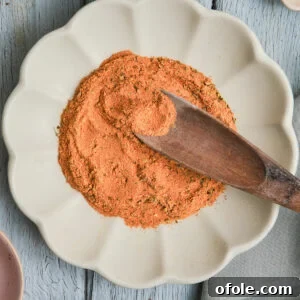 Cajun Flavor Hacks 11 Wooden spoon in a plate of Cajun seasoning substitute.