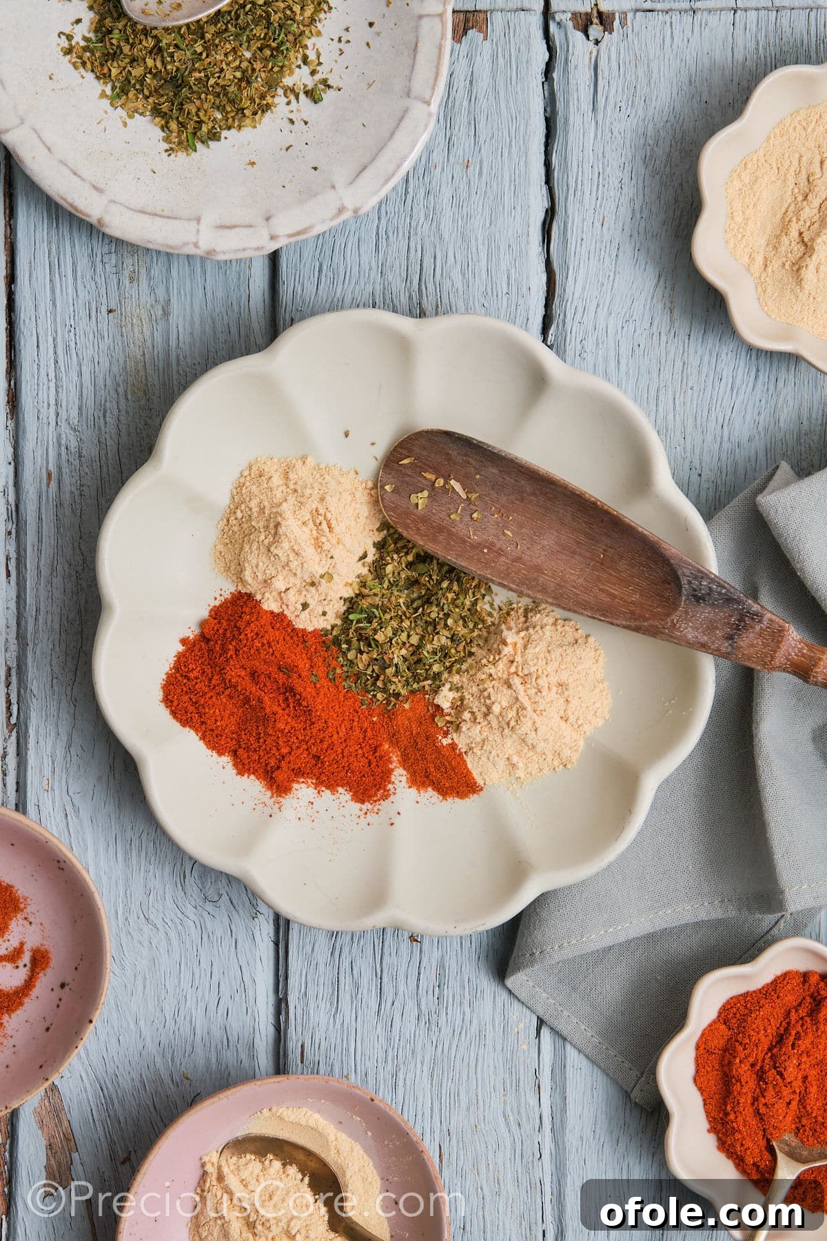 Cajun Flavor Hacks 8 Five distinct piles of seasonings artfully arranged on a white plate, before mixing.