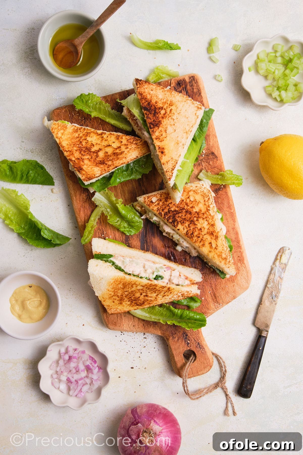 Creamy Chicken Sensation 3 Cut chicken mayonnaise sandwiches on a cutting board.