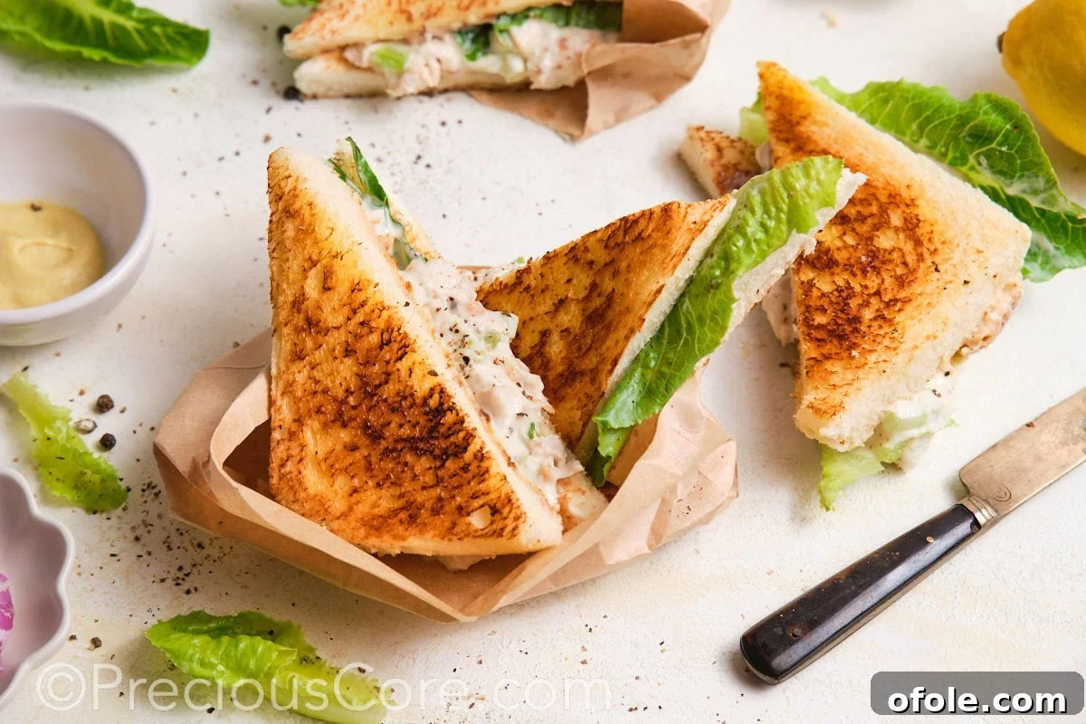 Creamy Chicken Sensation 6 Served sandwiches wrapped in parchment paper.
