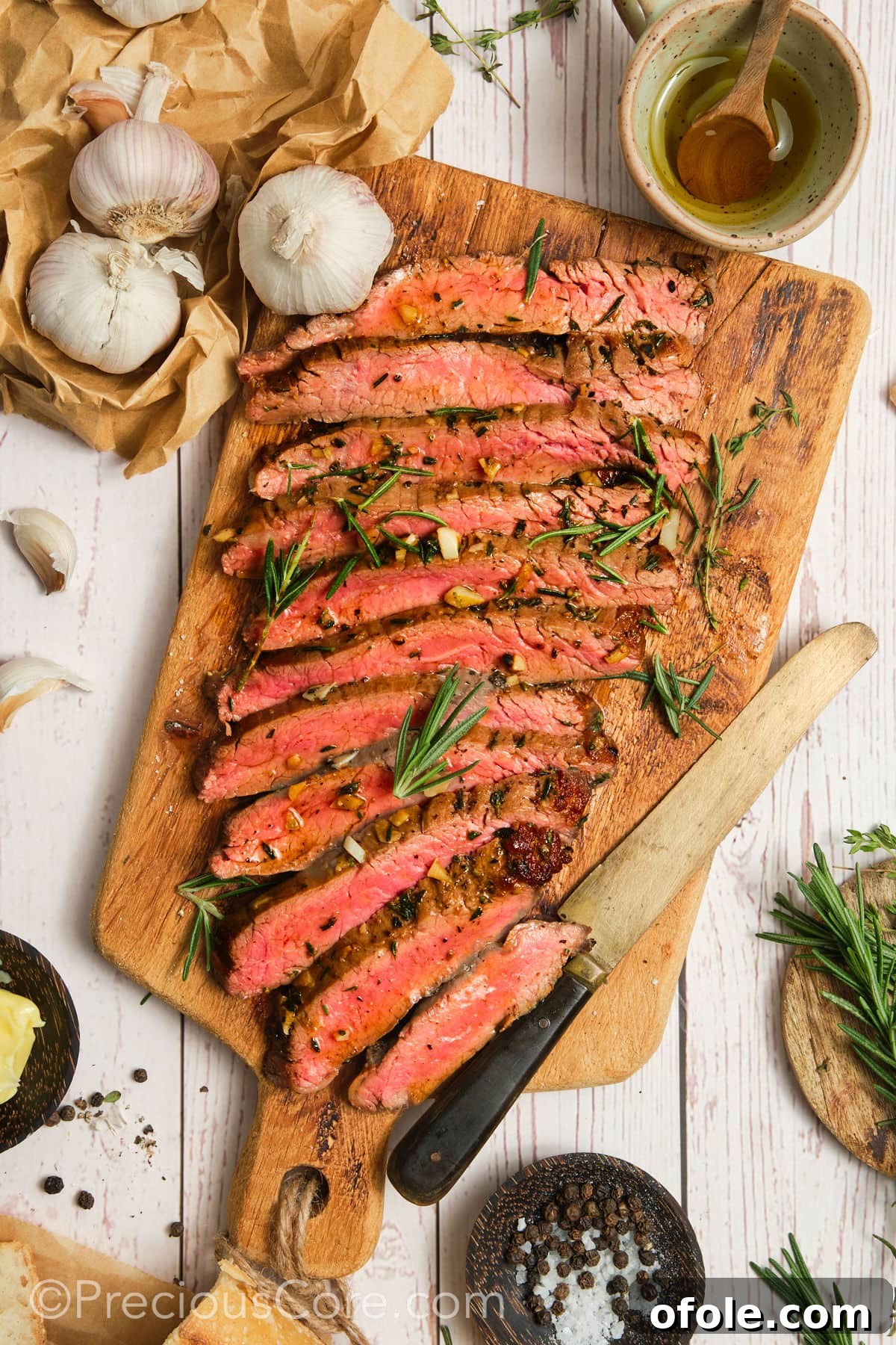 Thinly sliced flank steak showing a beautiful pink interior, ready for serving.