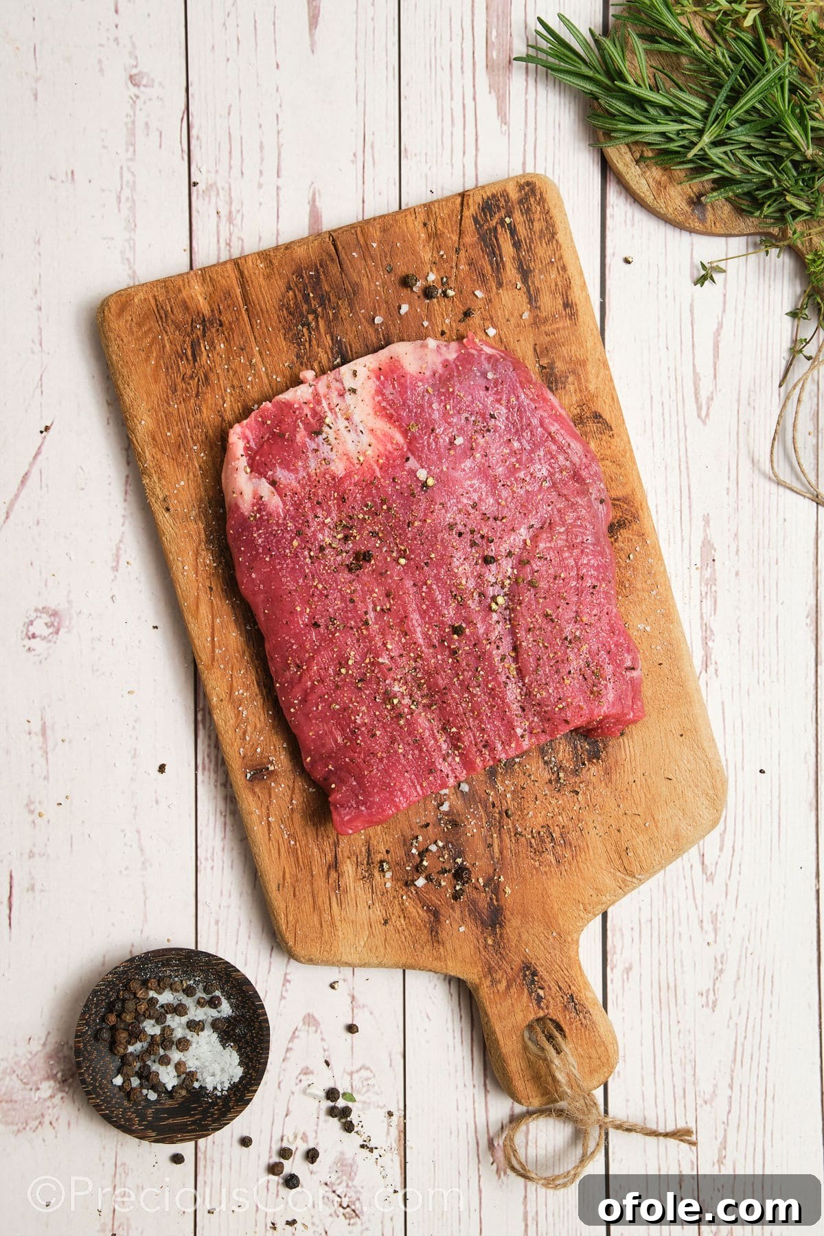 Seasoning flank steak evenly with salt and pepper on both sides.