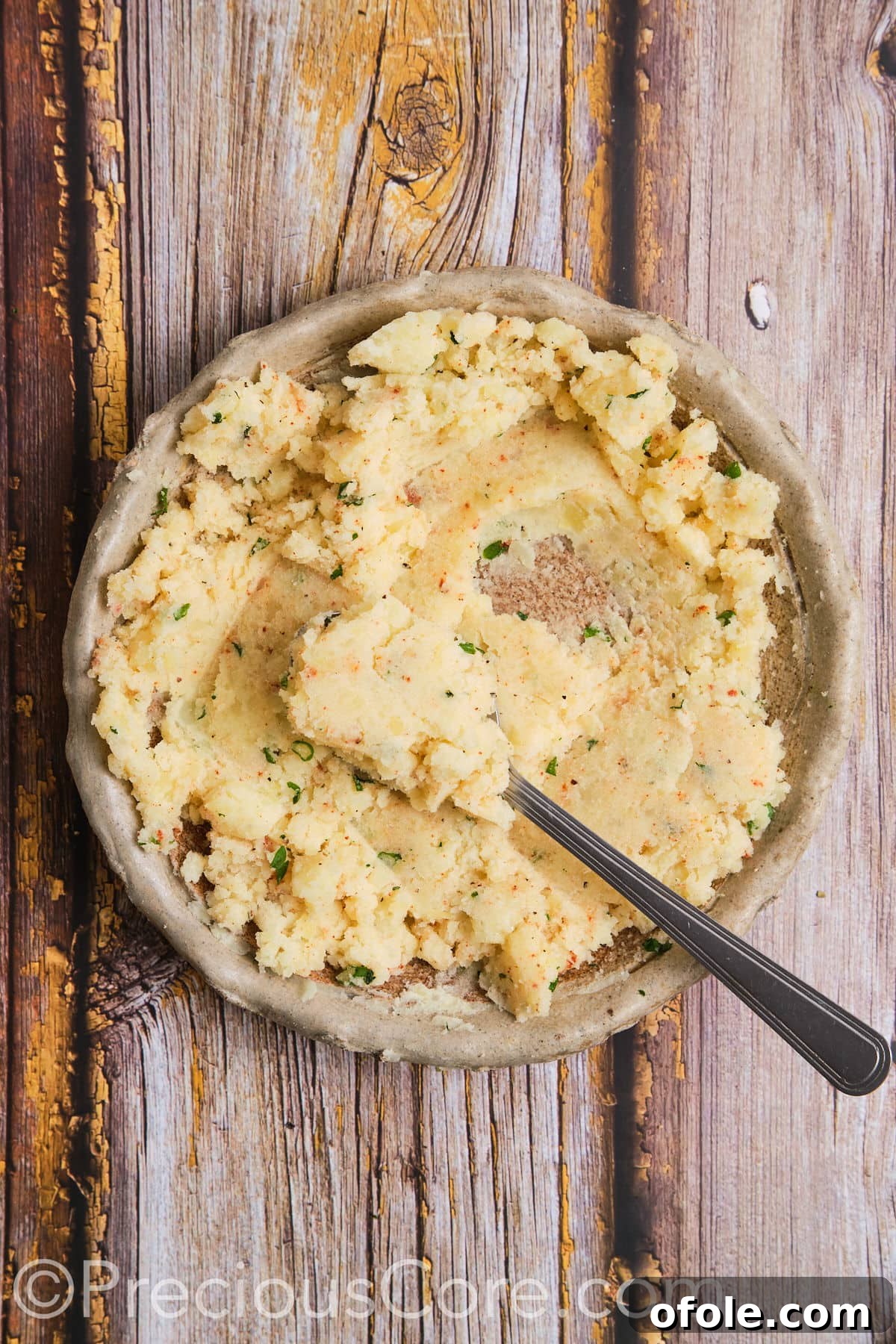 Mashed potatoes with various seasonings and herbs already mixed in, ready for forming.
