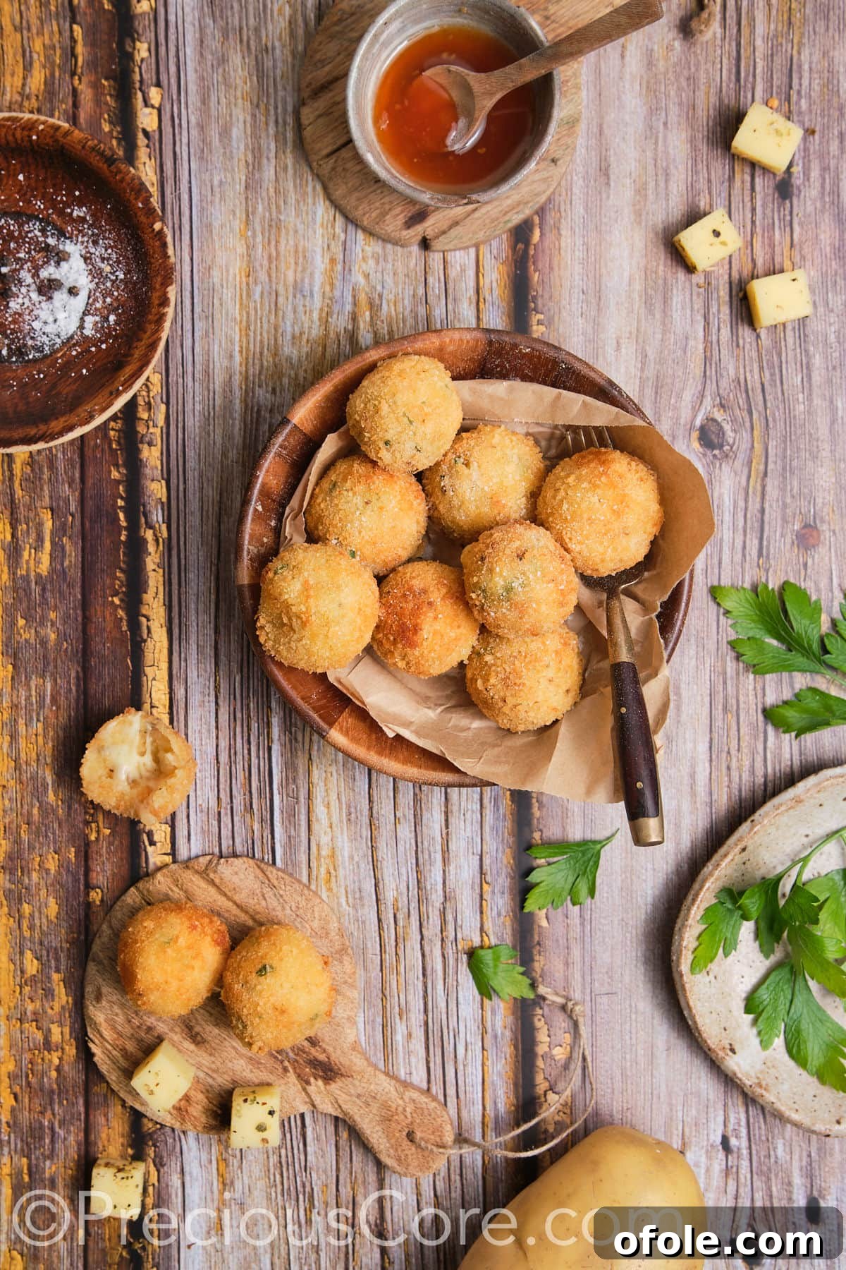 Potato balls served beautifully with a glossy dipping sauce, enticing and ready to eat.