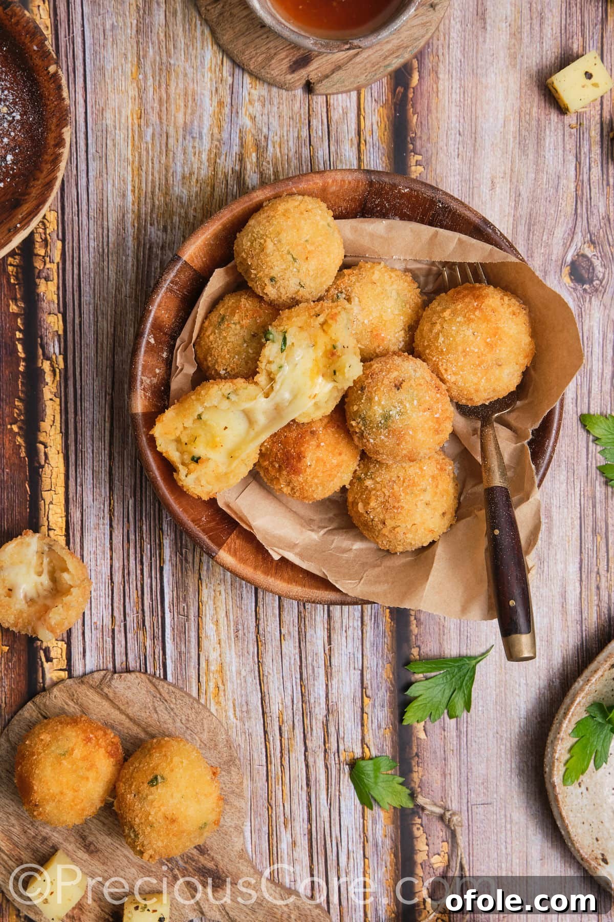 An overhead shot of several potato cheese balls artfully arranged, showcasing their uniform golden color.