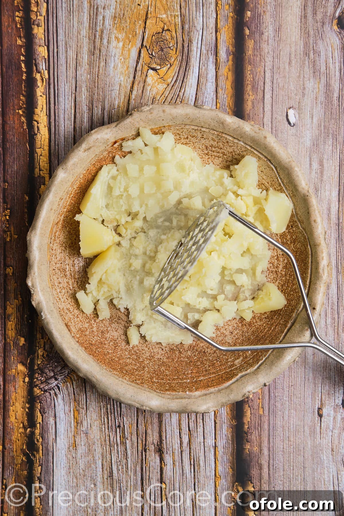A close-up of freshly mashed potatoes in a bowl, showing a smooth texture.