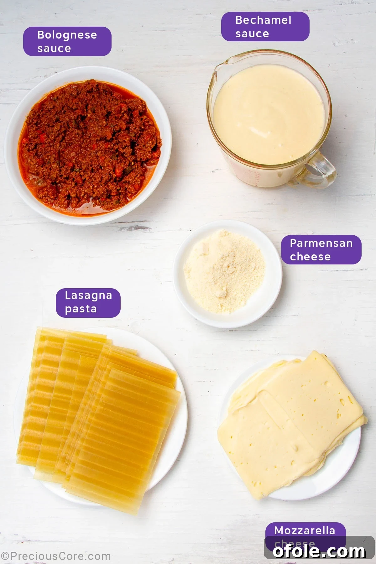 Creamy Béchamel Lasagna 6 All the assembled components for baking lasagna with béchamel sauce: prepared Bolognese and béchamel sauces in bowls, dry lasagna sheets, and bowls of shredded mozzarella and Parmesan cheese.