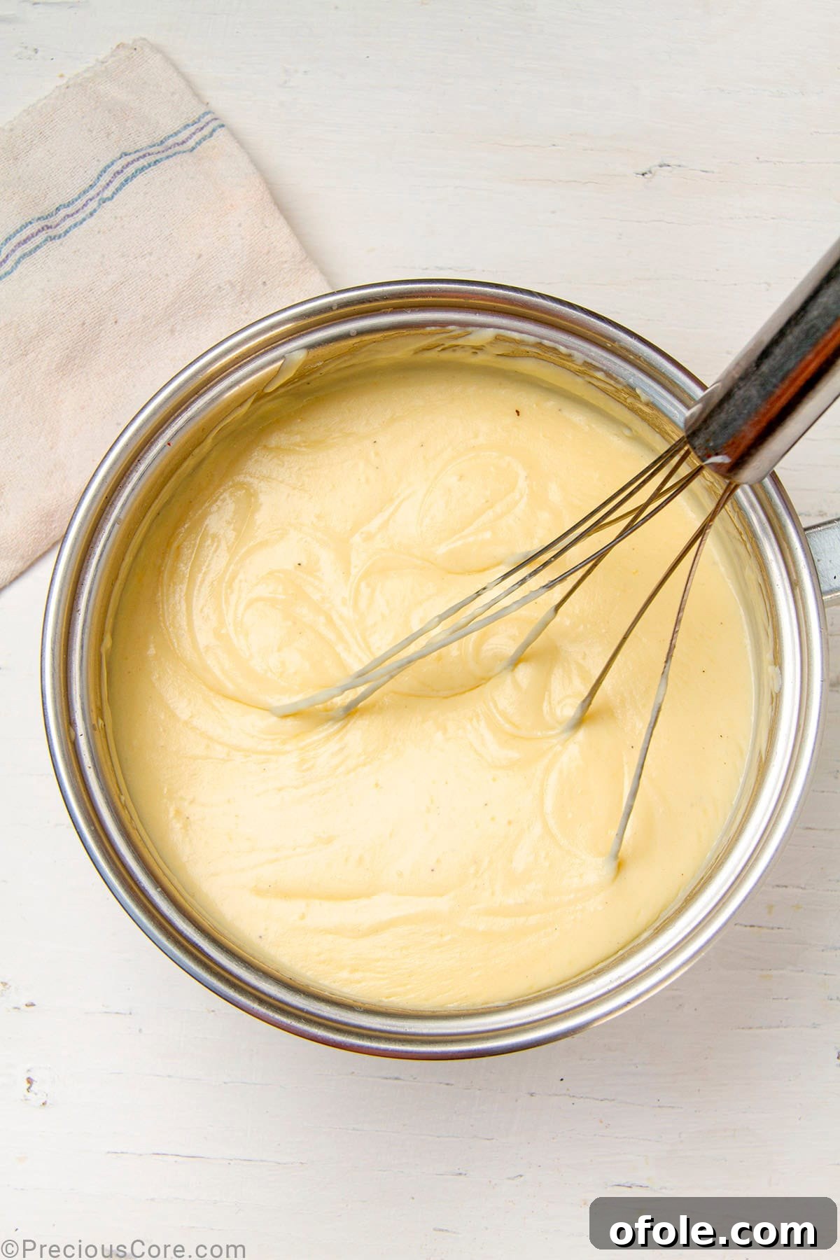 Creamy Béchamel Lasagna 10 A perfectly smooth and creamy homemade béchamel sauce resting in a pot, demonstrating the ideal consistency for the sauce.