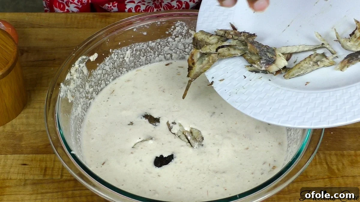 Incorporating an egg into the egusi paste for added richness and texture
