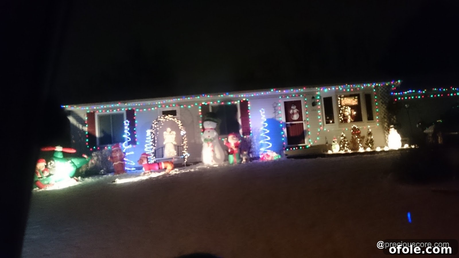 Residential street adorned with colorful Christmas lights