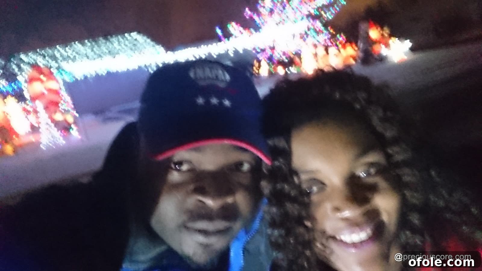 Christmas Lights and Holiday Sparkle 16 Family taking photos by Christmas lights at night