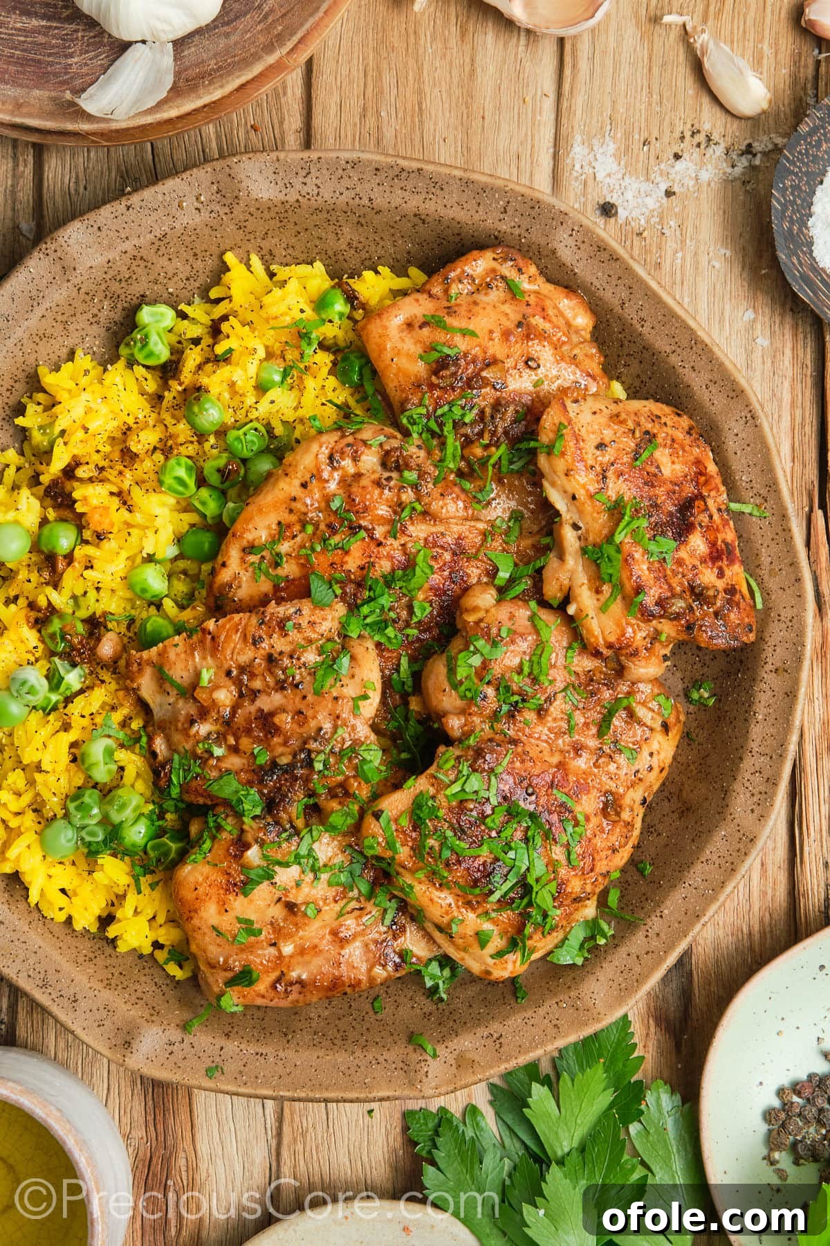 Juicy Skillet Chicken Thighs 2 Pan Seared Boneless Chicken Thighs with yellow rice, showcasing a perfectly golden crust.