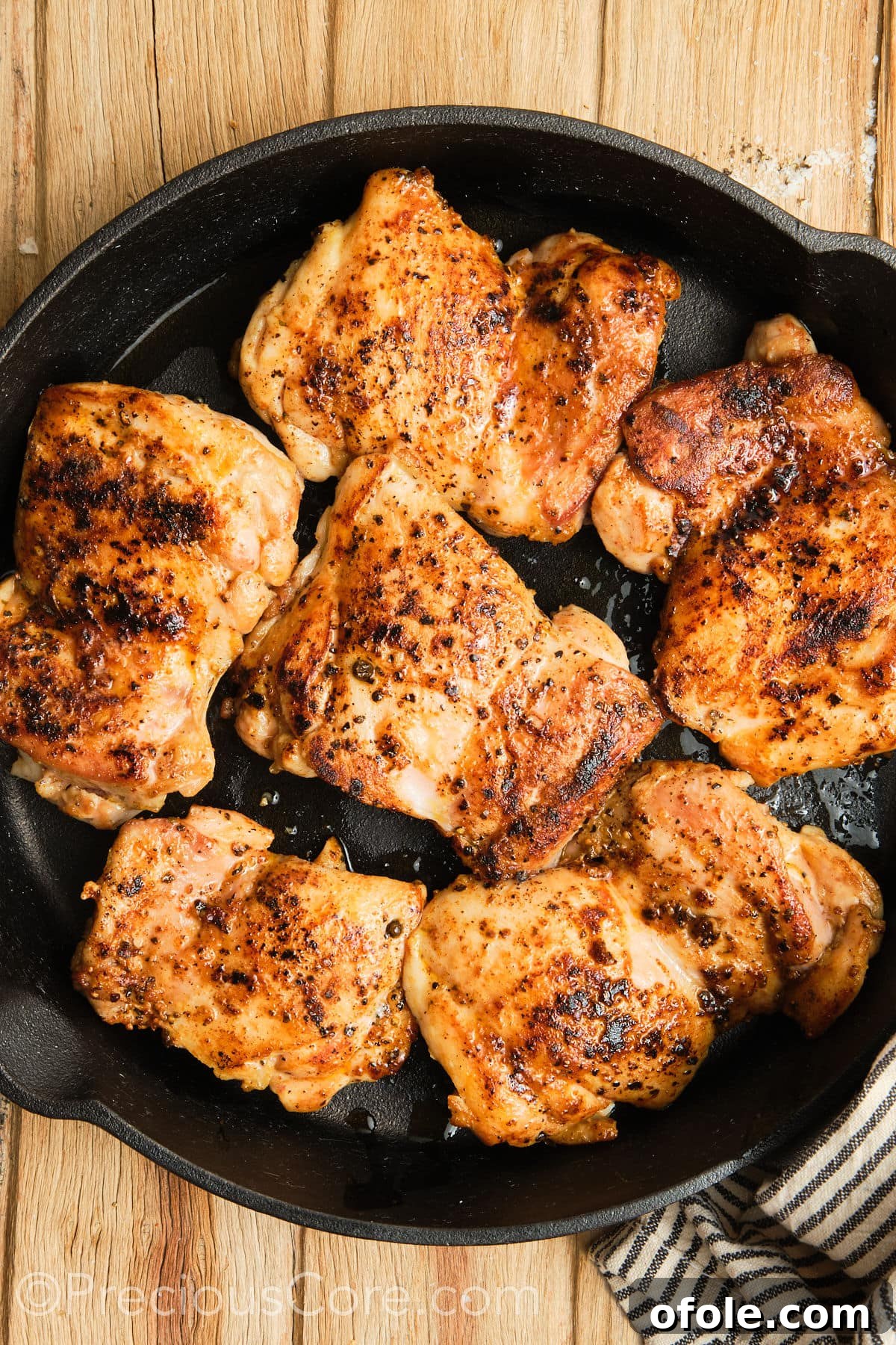 Juicy Skillet Chicken Thighs 13 Pan-seared boneless chicken thighs, golden brown and flipped in a skillet, continuing to cook.