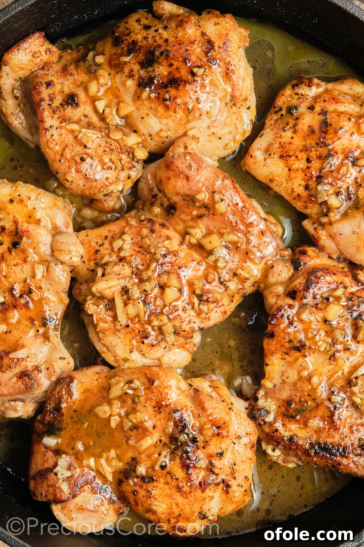 Juicy Skillet Chicken Thighs 16 Beautifully cooked Pan Seared Boneless Chicken Thighs resting on a platter, ready to be served.