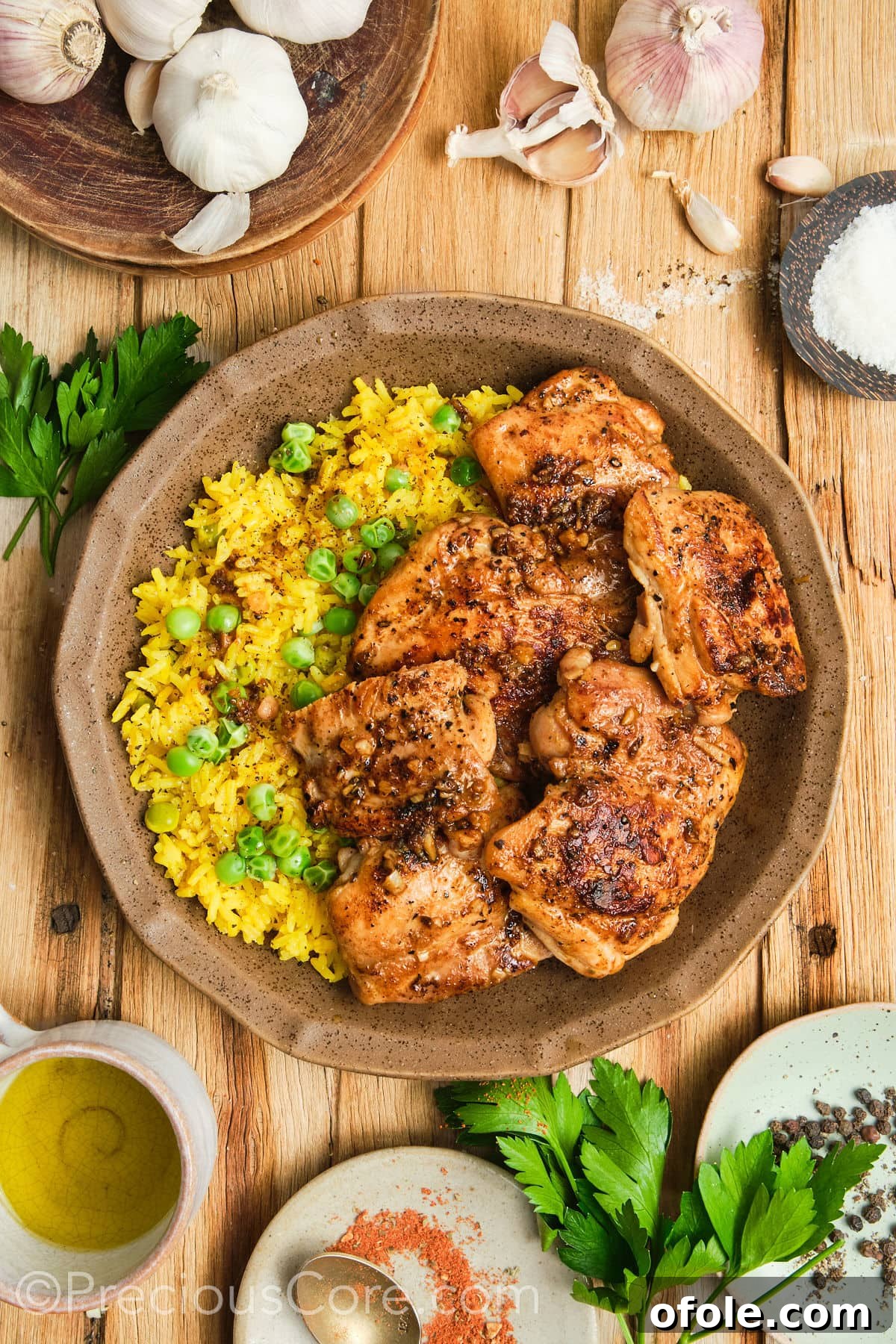 Juicy Skillet Chicken Thighs 4 Glistening golden pan-seared chicken thighs served in a bowl alongside fluffy rice.