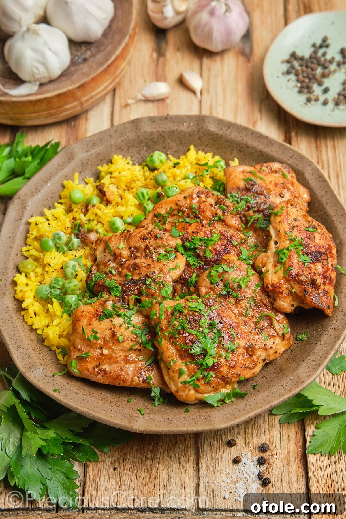 Juicy Skillet Chicken Thighs 9 Expertly seared chicken thighs arranged with a side of vibrant yellow rice, ready to serve.