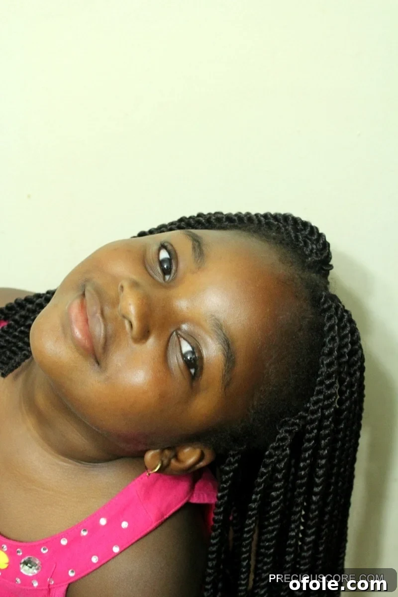 Beautiful crochet braids for kids in a natural style, showing a child smiling with neatly styled hair